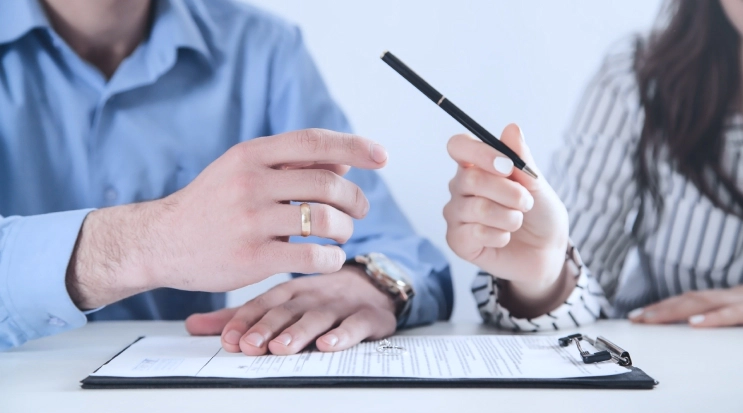 man and woman divorce appraisal paper ring on table woman giving pen to man russellville ar